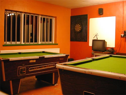 Games room equipped with two pool tables, dart board, TV and video.
